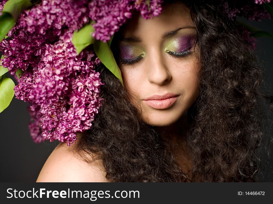 Girl in lilac garland eyes shut