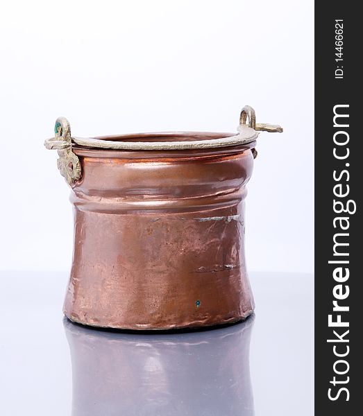 Brass container over glass and white background