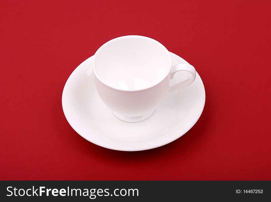 White porcelain cup on a red background