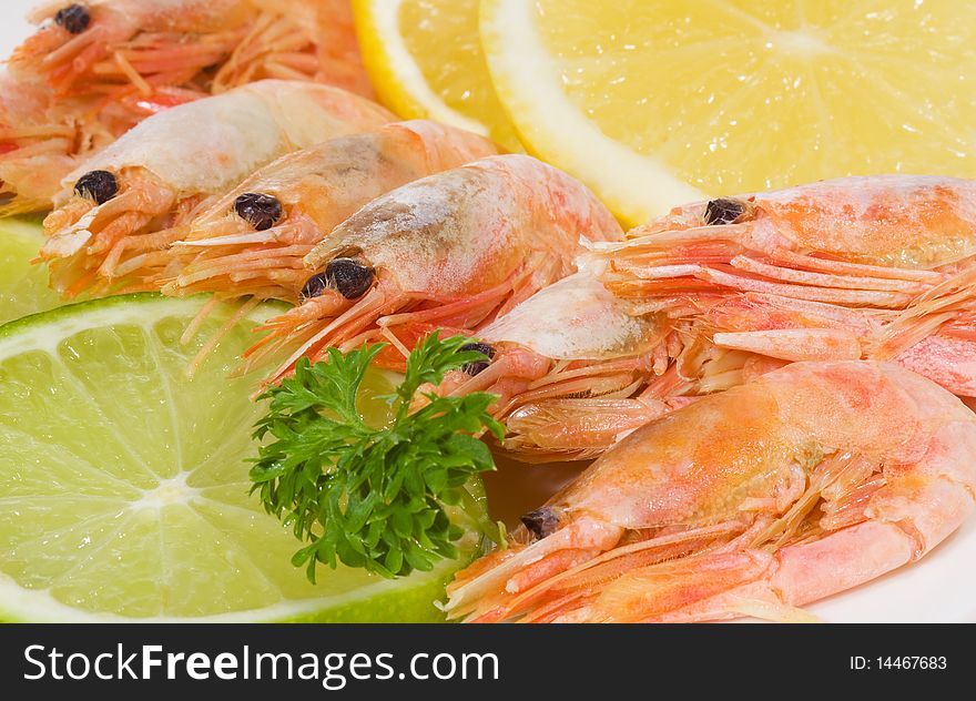 Shrimps with lime and lemon as background