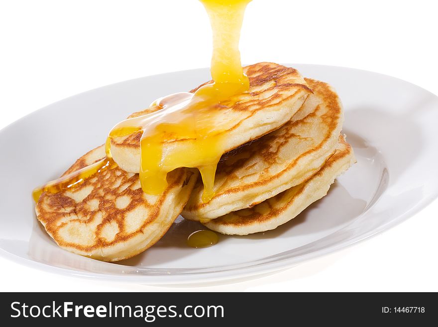 Pancakes with honey on white background