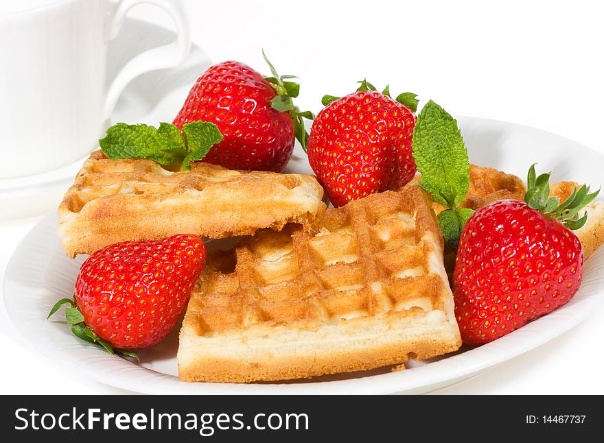 Waffles with strawberries on white background