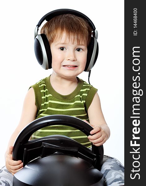 Portrait of a little boy in headphones playing with television-game device. Isolated over white background. Portrait of a little boy in headphones playing with television-game device. Isolated over white background.