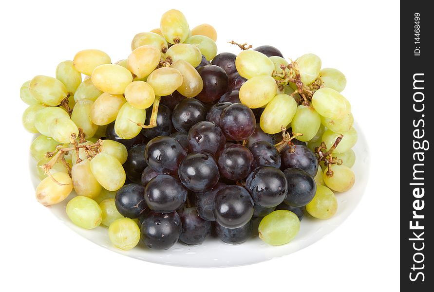 Plate with ripe grape insulated on white background