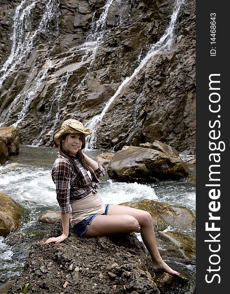 Cowgirl With Hat By Waterfalls