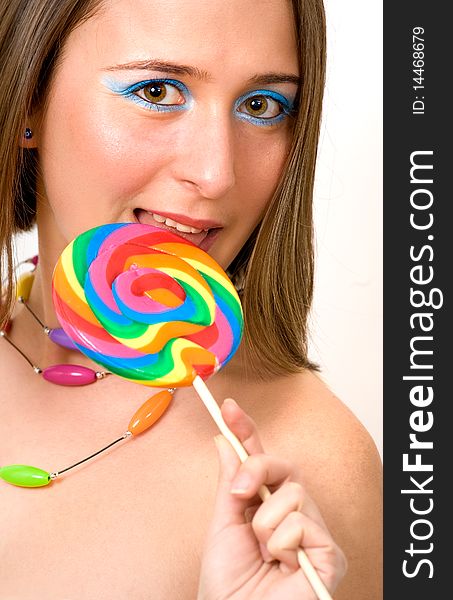Pretty young woman with colorful lollipop, indoor shoot