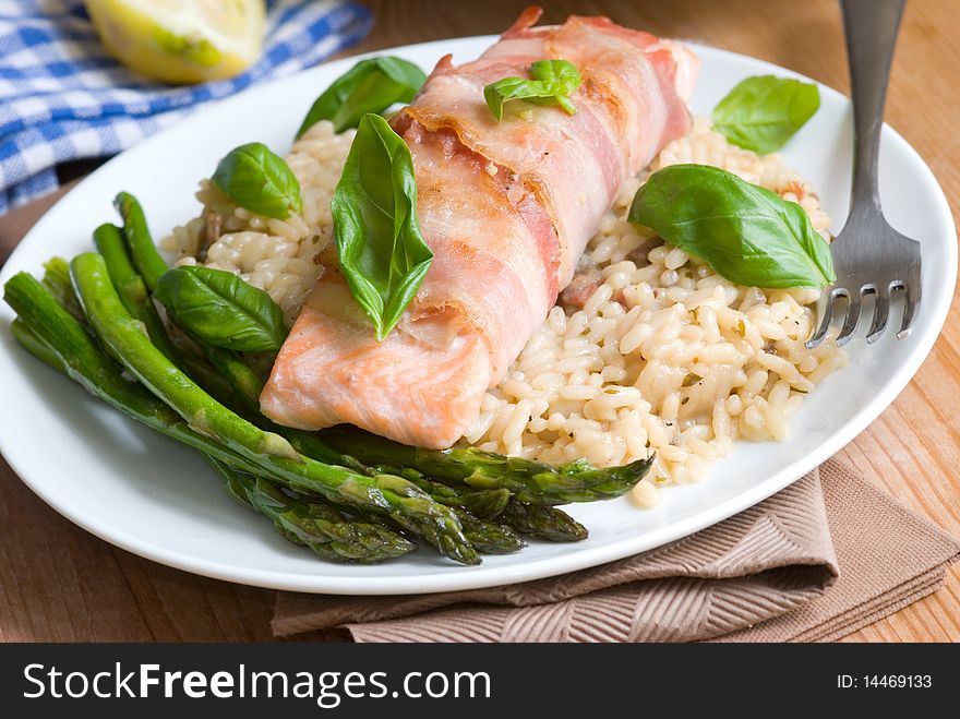 Grilled salmon and pancetta wrap with rice and asparagus. Grilled salmon and pancetta wrap with rice and asparagus