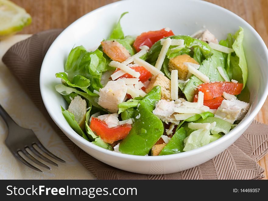 Light chicken caesar salad in a bowl