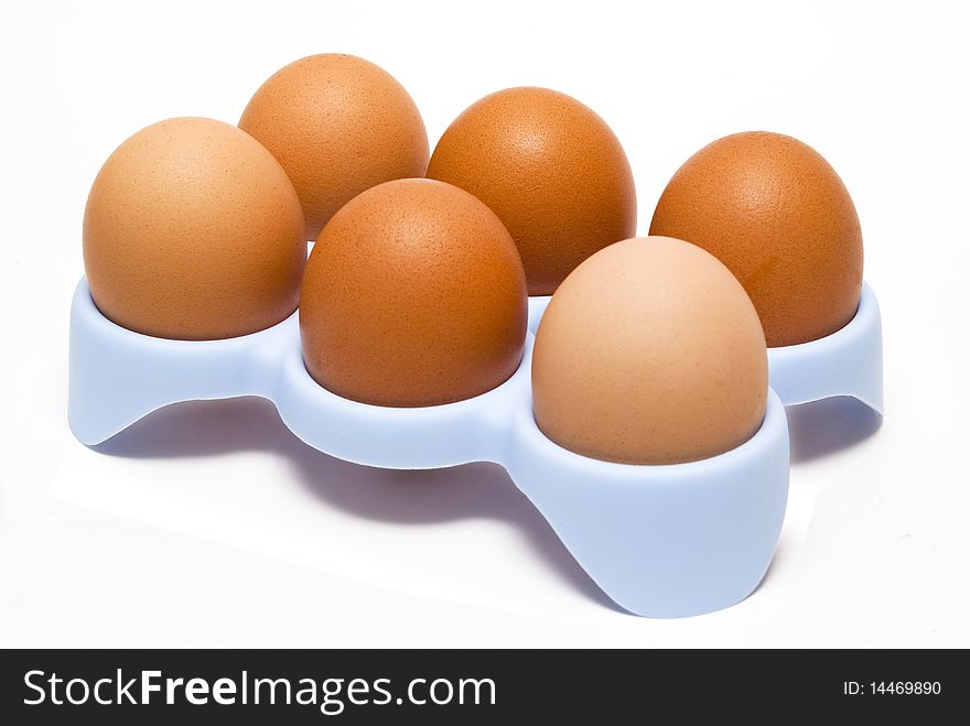 Eggs in tray, white background, close up.