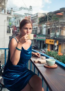 Beautiful Woman Sitting On Cafe Terrace. Panoramic Street View Of Da Lat City, Little Paris Of Vietnam Stock Images