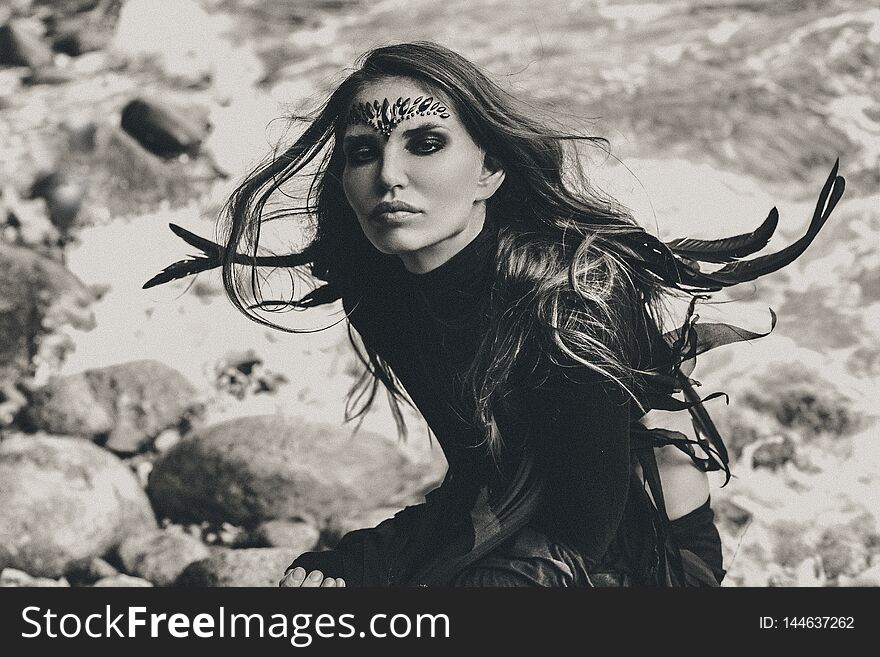 Stylish young woman outdoors. witch craft spiritual concept black and white portrait
