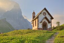 Morning Scenery Of A Lovely Church At The Foothills Of Rugged Mountain Peaks Stock Photo