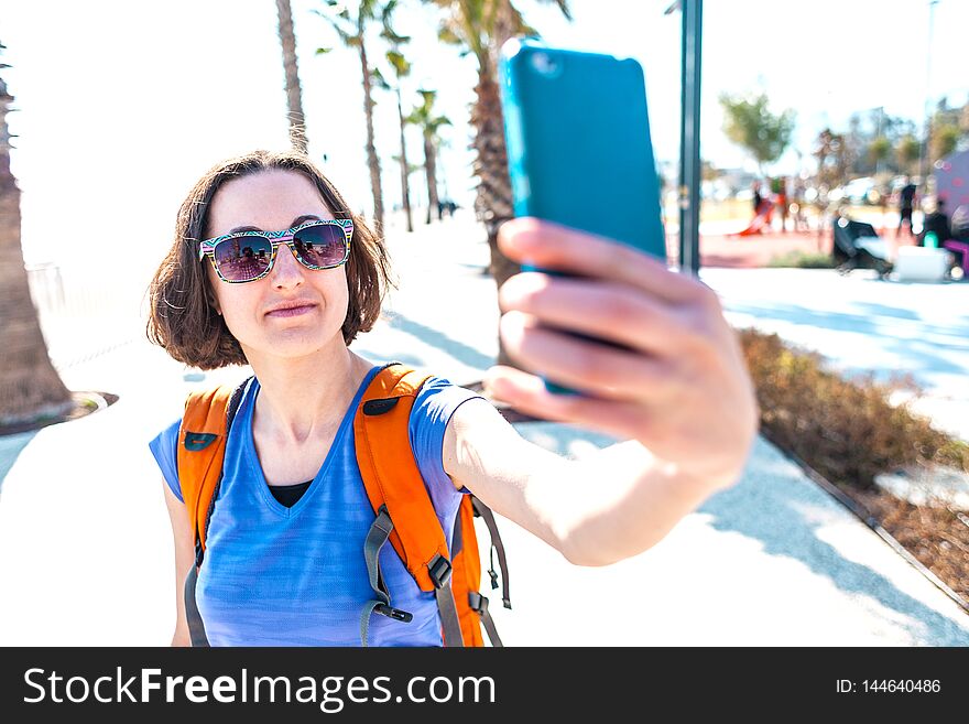 A girl takes a selfie on the waterfront