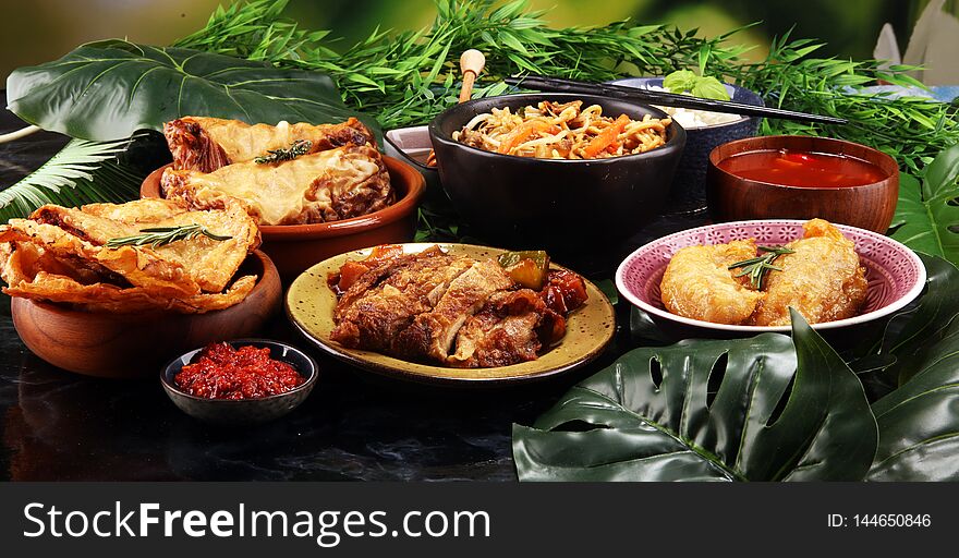 Assorted Chinese food set. Chinese noodles, fried rice, peking duck, dim sum, spring rolls. Famous Chinese cuisine dishes on table