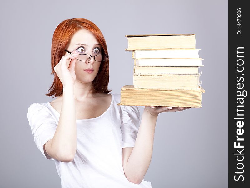 Red-haired businesswoman keep books in hand.