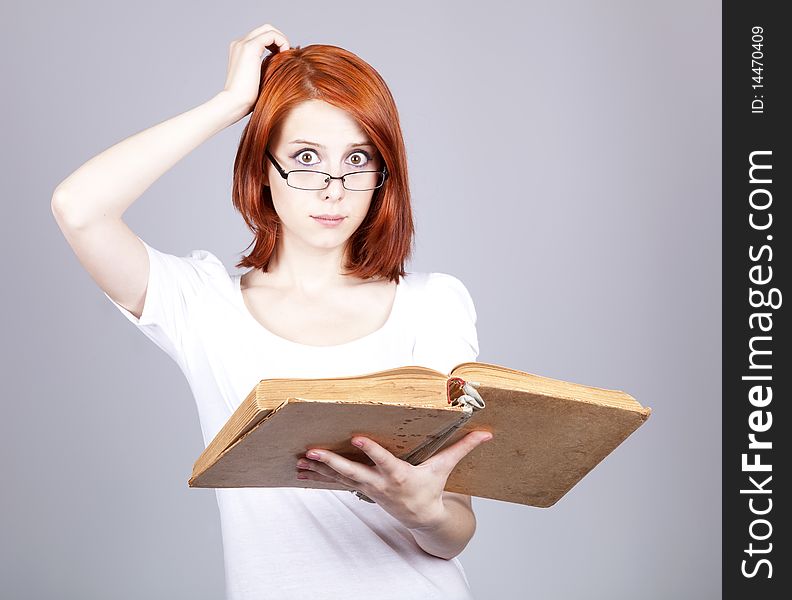 Red-haired businesswoman  keep books in hand.