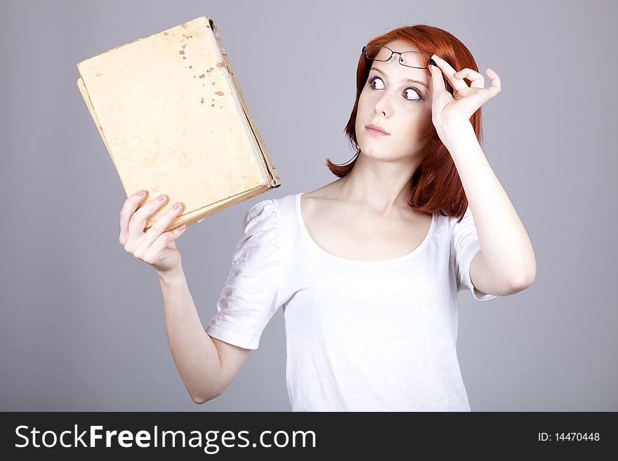 Red-haired businesswoman keep book in hand.