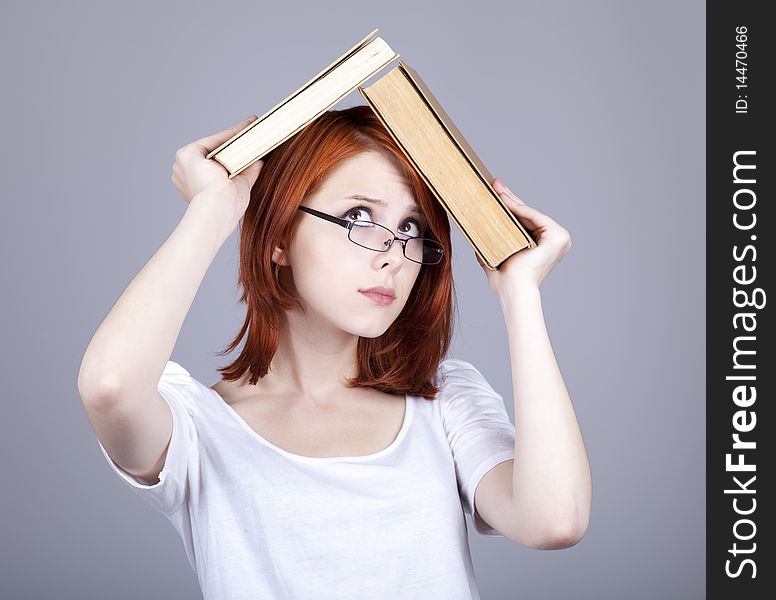 Red-haired businesswoman keep books in hand.