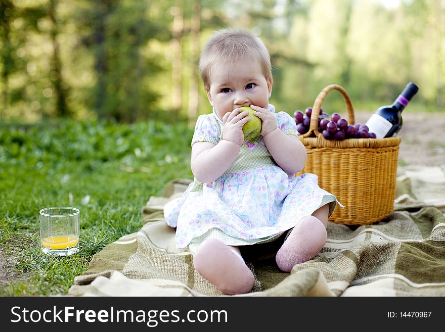 Baby girl eating green apple in the nature. Baby girl eating green apple in the nature