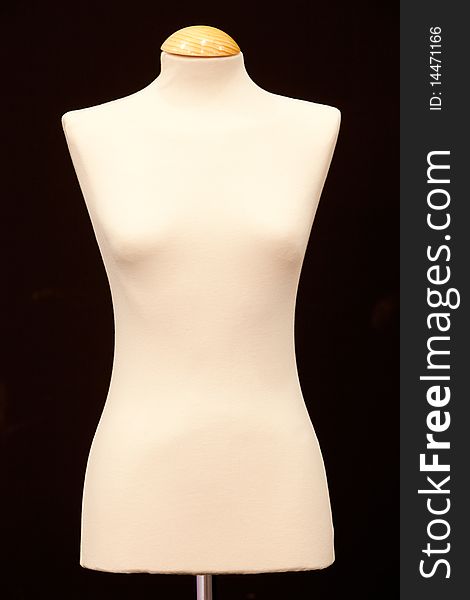 Bare-breasted mannequin isolated on black background