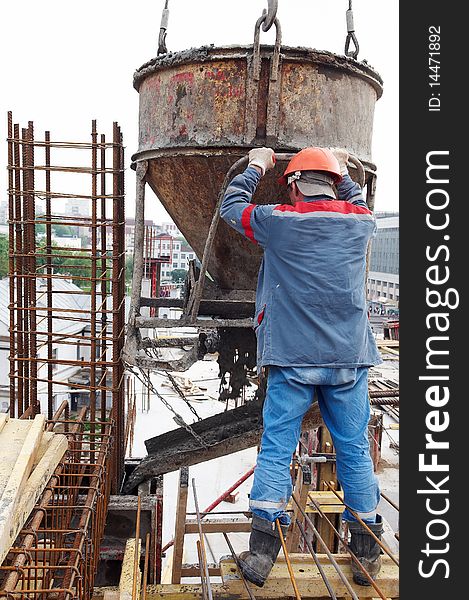 Construction building worker at construction site pouring concrete in form. Construction building worker at construction site pouring concrete in form