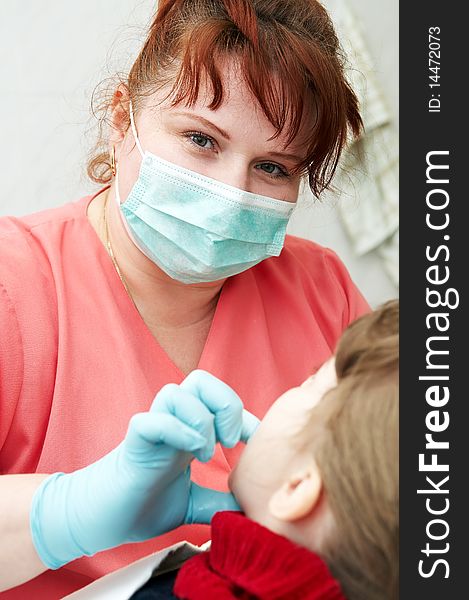 Orthodontic doctor examine teeth and gums of little girl jaw. Orthodontic doctor examine teeth and gums of little girl jaw