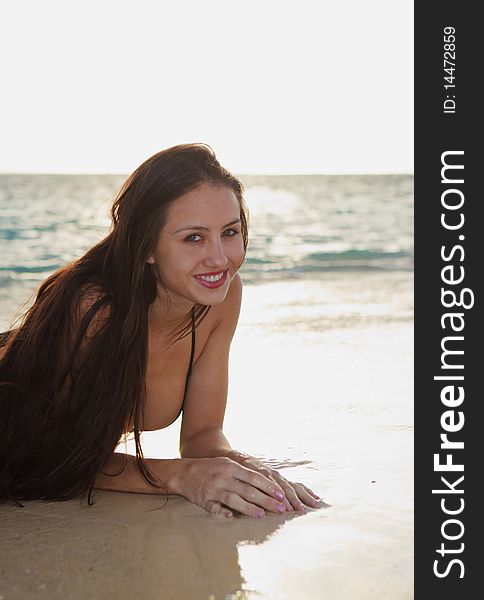 Beautiful young woman at the beach in hawaii at sunrise. Beautiful young woman at the beach in hawaii at sunrise