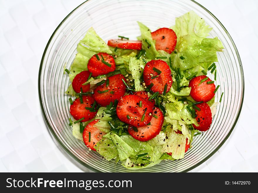 Salad bowl with ice salad, fresh strawberries and chives, pepper. Salad bowl with ice salad, fresh strawberries and chives, pepper.