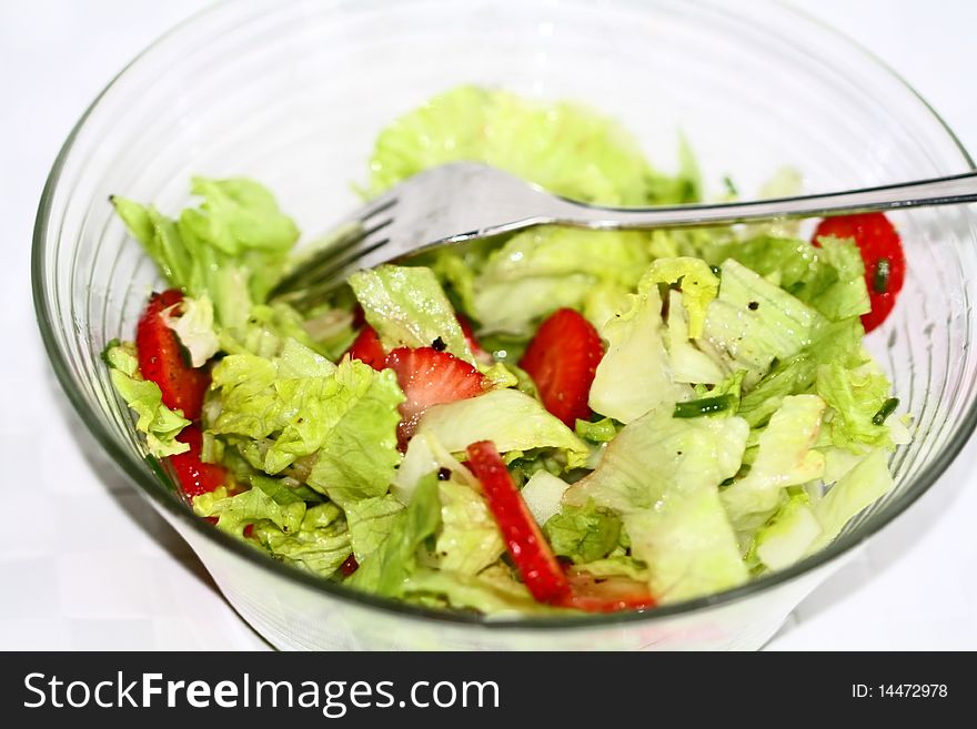 Salad bowl with fresh strawberries, ice salad and chives, pepper. Salad bowl with fresh strawberries, ice salad and chives, pepper.