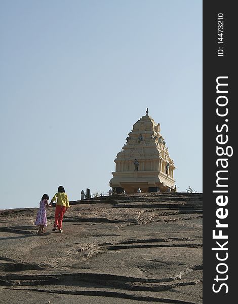 Two sisters climbing rock bed to reach Kempegowda Tower at Lalbagh, Bangalore, India, Asia. Two sisters climbing rock bed to reach Kempegowda Tower at Lalbagh, Bangalore, India, Asia