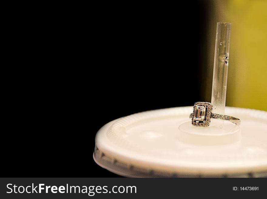Diamond Ring On Top Of A Soda Cup