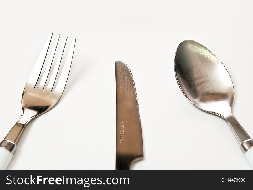 Knife fork spoon in the table. Grey background