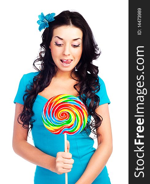 Pretty happy brunette girl with a lollipop in her hand