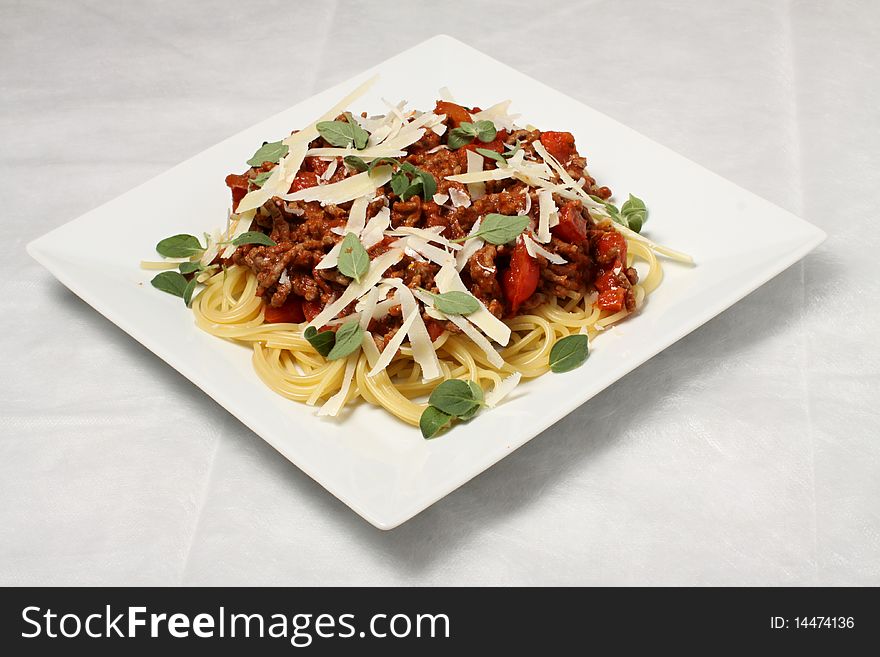 Yellow spaghetti with red tomato sauce and green leaves. Yellow spaghetti with red tomato sauce and green leaves