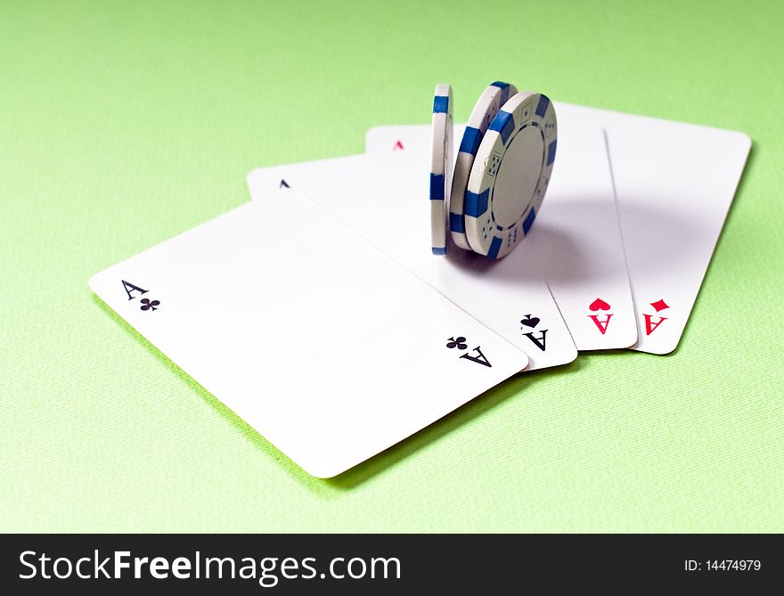 Cards and chips for poker night, four of a kind raising