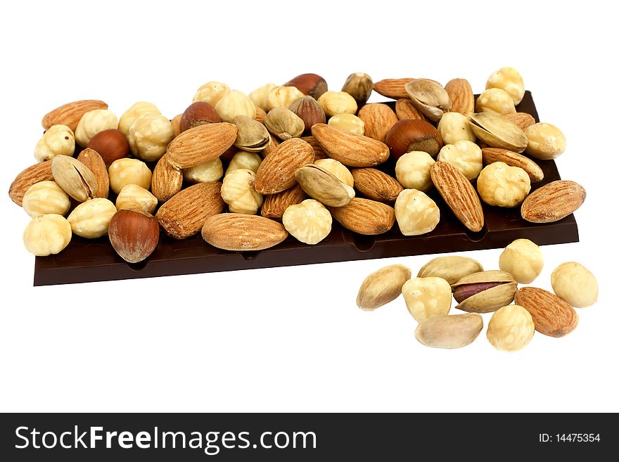 Bar of chocolate with variety of nuts above isolated on white background. Bar of chocolate with variety of nuts above isolated on white background