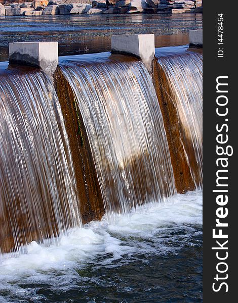 The curtain of water falling over a dam.