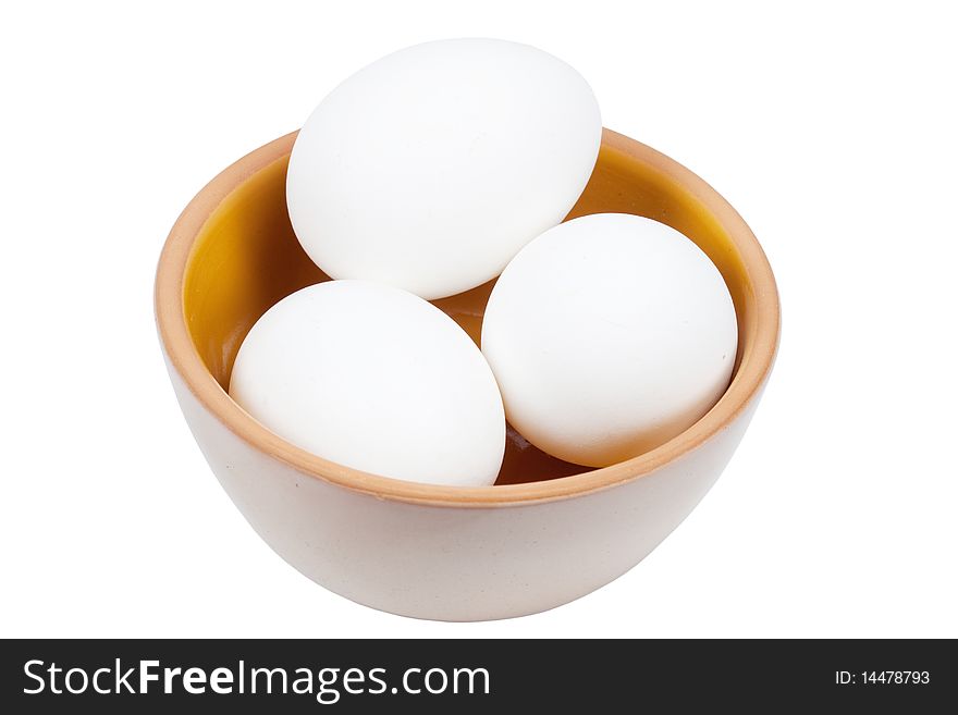 Three eggs in a plate it is isolated on a white background