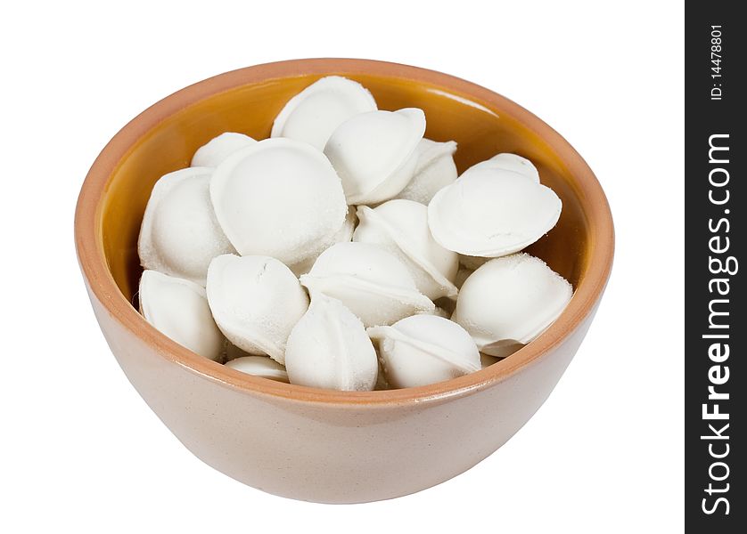 The frozen pelmeni in a plate it is isolated on a white background