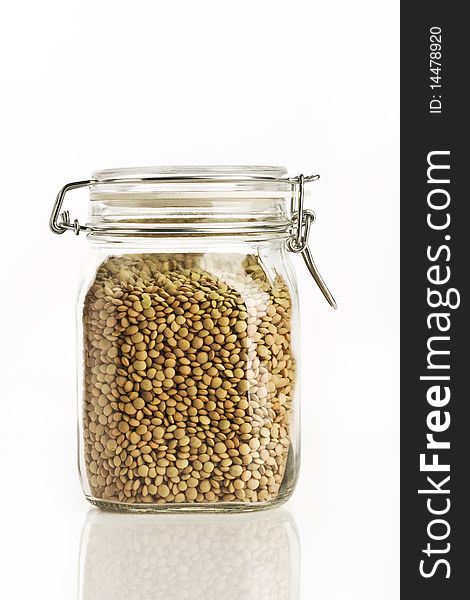 Jar with lentils on white