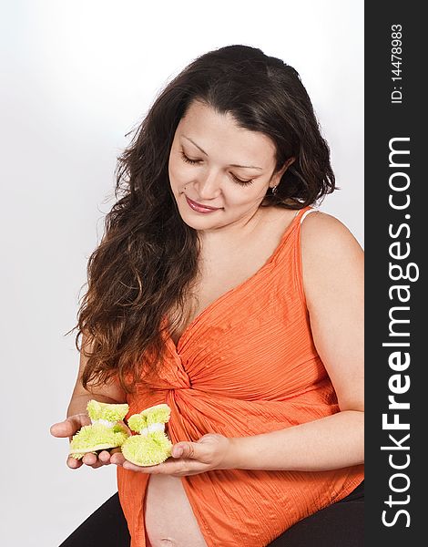 Pregnant Woman Holding Bootees