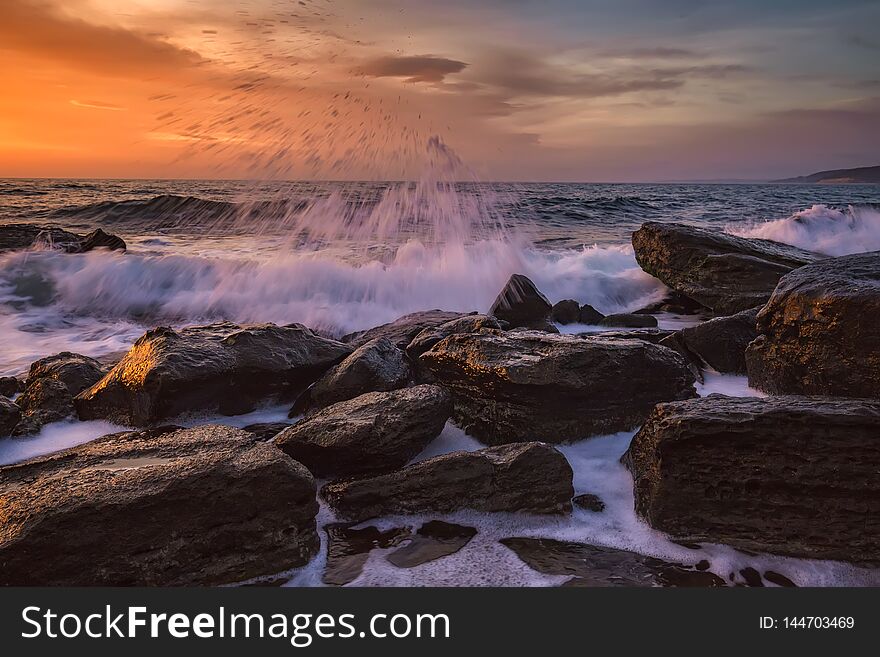 Beautiful motion blur sea waves over the rocks