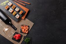 Set Of Sushi And Maki With A Bottle Of Wine On Stone Table. Top View Royalty Free Stock Photos