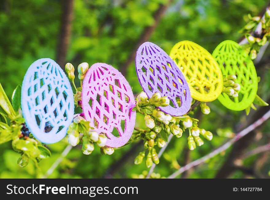 Easter eggs made of colored felt with flowering branches of fruit tree. Postcard, banner for Easter