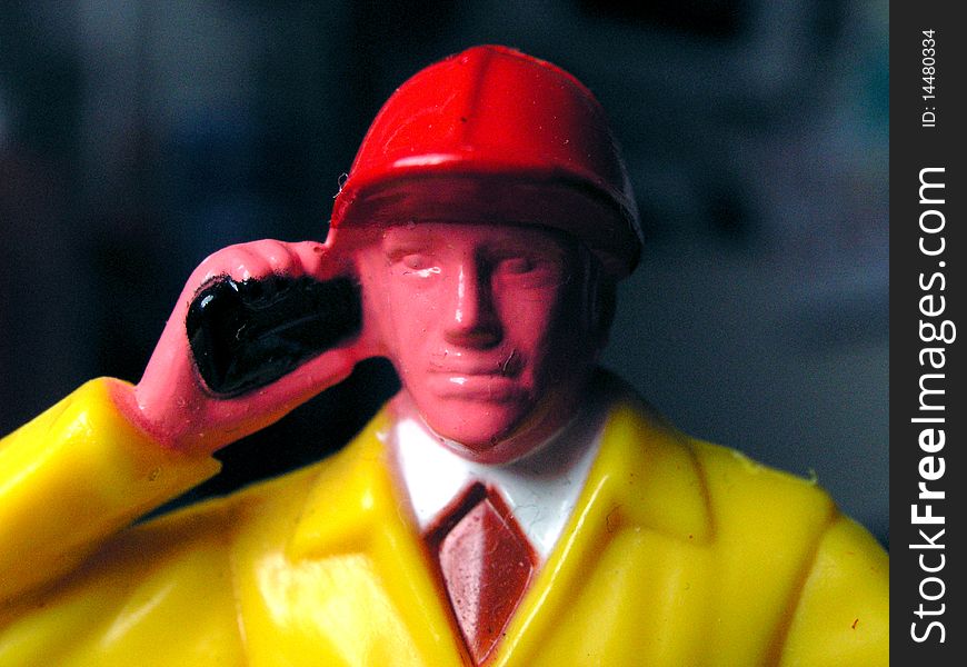 Toy worker with telephone in room