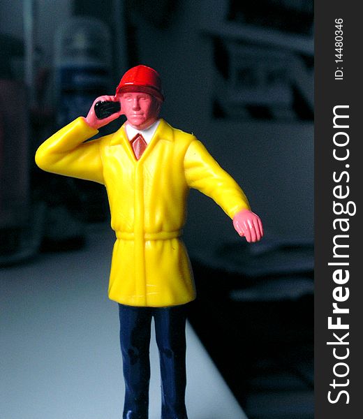 Toy worker with telephone in room
