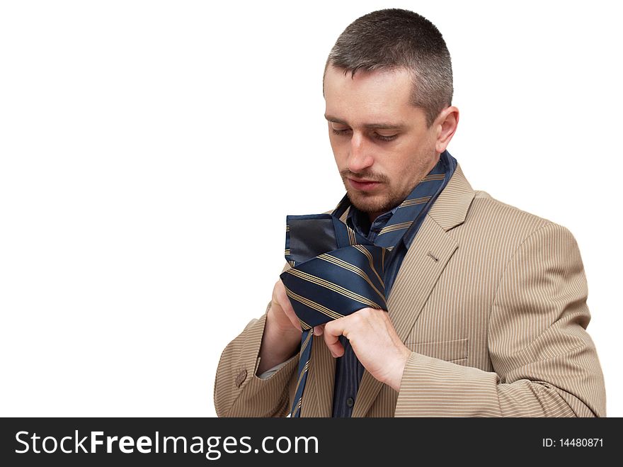 The man fastening a tie on a white background