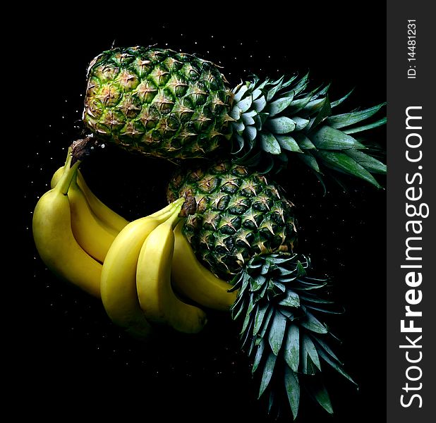 Bananas And Pineapple On Black Background