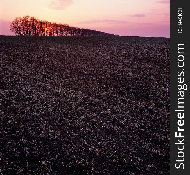 Sunset over a ploughed field. Sunset over a ploughed field.