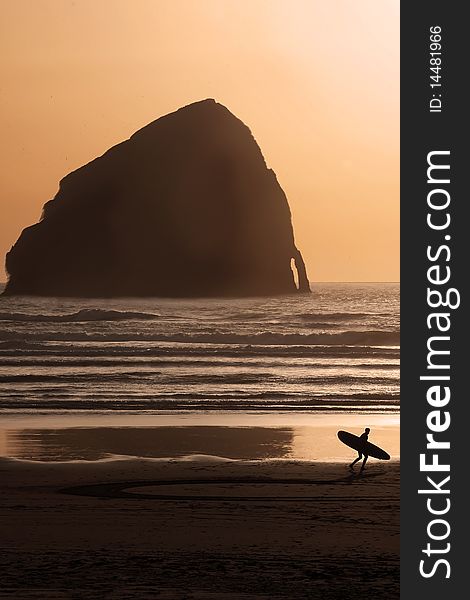 A surfer looks out at the ocean deciding if there is time for one more ride. A surfer looks out at the ocean deciding if there is time for one more ride.